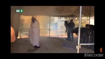 israeli soldiers throw flash bangs and tear gas (or smoke) grenades at palestinian civilians praying