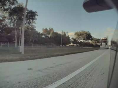 Road rage trucker purposely rides in emergency shoulder and attempts to smash into car&mdash; FL Turnpike