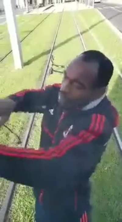 Train warns cyclist on railroad tracks.