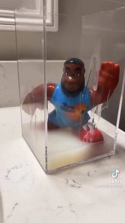 Some dude is trying to recreate the cum jar with a lebron James toy....