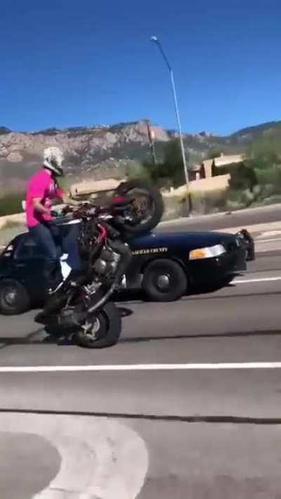 Cop pulls gun on biker for wheelies