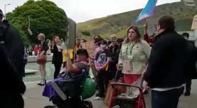 Counterprotestor at "women's rights demo" in Edinburgh Scotland grunts "witch" at a woman