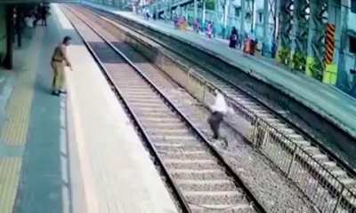 Crossing a railway track in front of a train