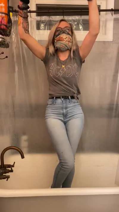 Girl tied up pees her jeans