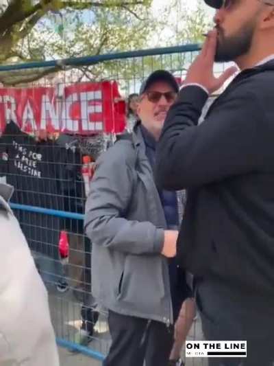 Protest agitator yelling "Stop it" as he claims the big guy is pushing him and the crowd stands by and tries to calmly talks him off the ledge.