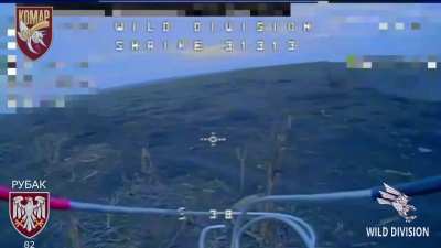 A Russian soldier tries to take down a Ukrainian drone with a stick 