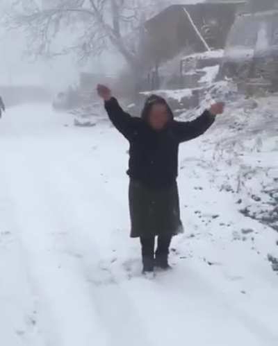 Babushkas calling for their friend to come out and play in the snow