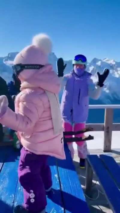 Baby dancing to house music at a ski resort