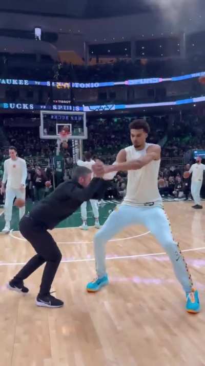 How a trainer prepares a 7' 4" NBA player for a game.