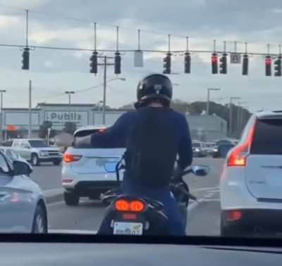A guy having a little party on his bike