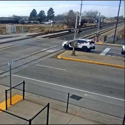 Impatient driver rear-ends car into train tracks. Seconds later, a train smashes it