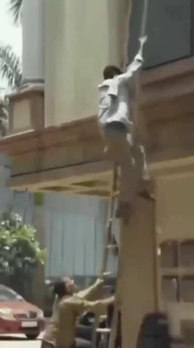Let me just record this guy doing work on a building