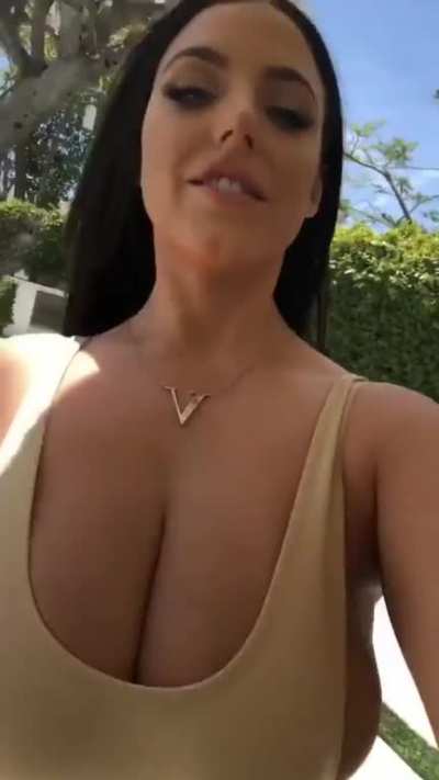 Angela walks for us again. Her top can hardly hold her breasts in.