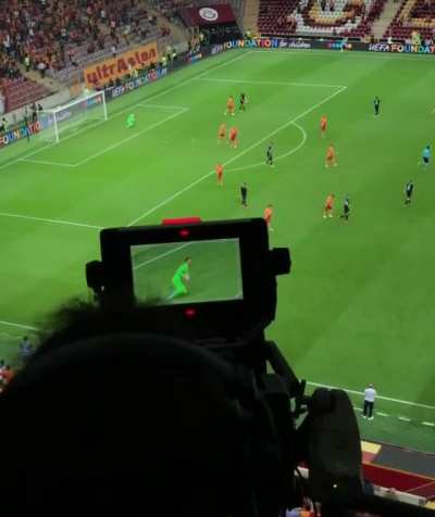 Camera operator following gameplay at professional soccer league match