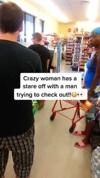 Girl having a stare off with a stranger in the line at the store