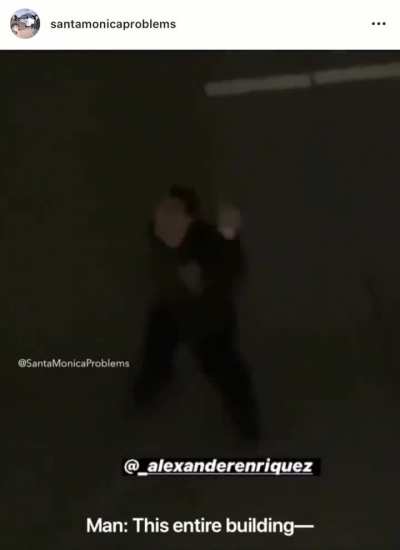Man condemns building from the middle of a highway at night
