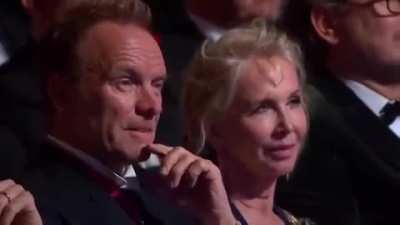 Sting watching his song being performed.
