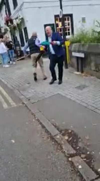 Racist man dual wielding umbrellas