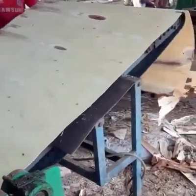 Peeling a log into veneers. Plywood results when they are press-glued together
