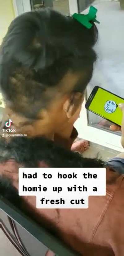 kid does a fabulous job cutting his friend's hair