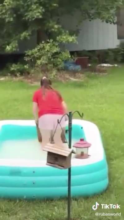 Girl saves a squirrel from drowning.