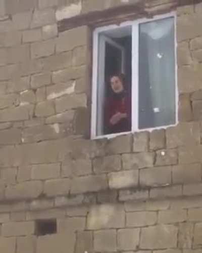 Babushka throws snow at friend