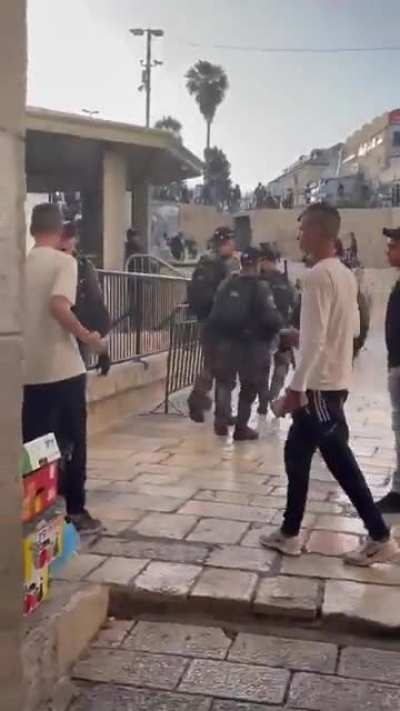 Israeli soldiers squaring up and assaulting Palestinian child