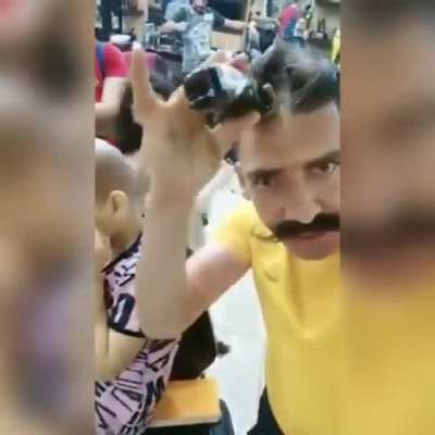 Syrian Barber comforts a girl after cutting her hair cause she had a skin disease and she thought that she became ugly, " I'm ugly " she says, " no you are not ugly " he responds, and then he asked her to cut his hair off for him to show her that she does