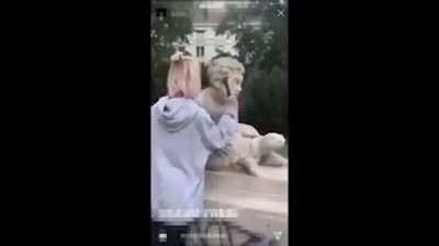 Stupid girl destroys 200 year old statue to post it on Instagram