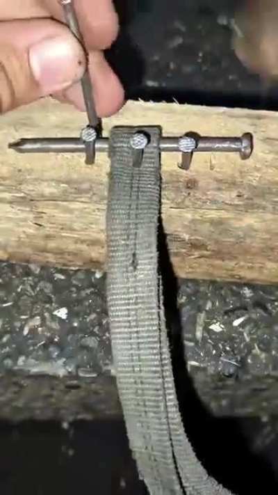 Thinking quickly Dave crafted a strap using a piece of wood, six nails and a strap