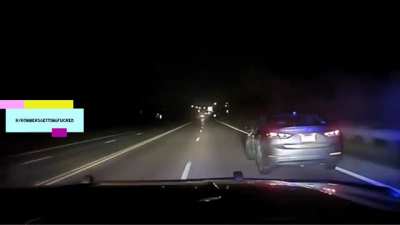 Robber who carjacked someone gets chased by police. He tries to bail from the car while it's moving in an attempt to trick the cop into continuing the chase without him in it.