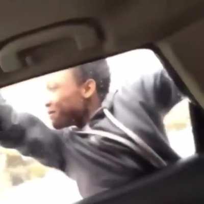 Mooda outside of a moving car with some females