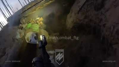 GoPro footage of a russian getting shot in the face at close range by a soldier from the 12th "Azov" Special Forces Brigade of the NGU while clearing trenches