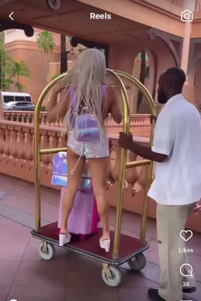 The workers look so annoyed. The one guy even shakes his head &ldquo;no&rdquo; when she&rsquo;s on the luggage cart