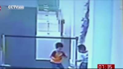 Mother films her kids as they damage art installation. The piece was created from individual strands of glass and took 27 months to complete.