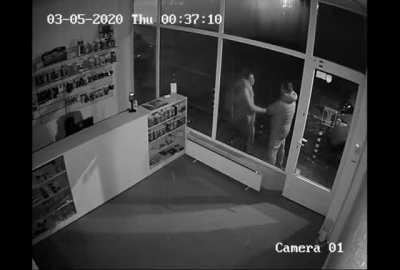 Angry woman headbutts shop window