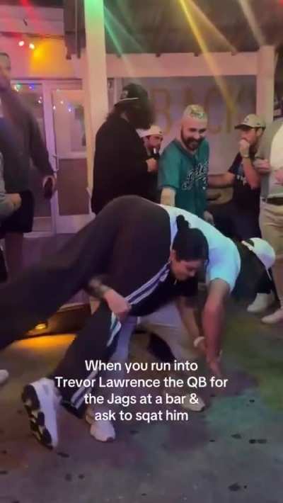 Jaguars star QB Trevor Lawrence has gone viral for allowing a female fan at a bar to SQUAT him.