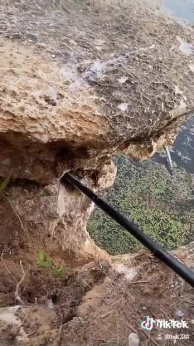 People destroying a natural rock formation for fake internet points.