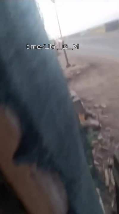 Russian soldiers fire towards a FPV drone with small arms, it explodes while still in the air, near Robotyne