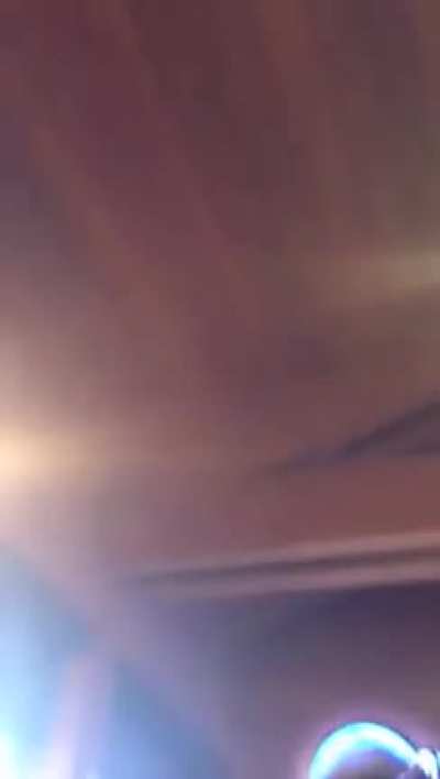Wave breaks through seaside restaurant window.