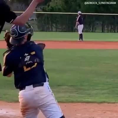 Shows no ball in hand or glove, then throws a strike.