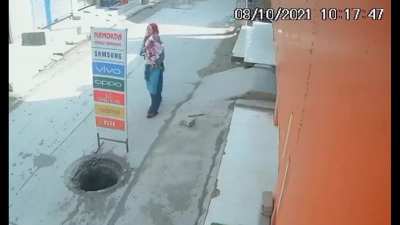 Mother With Baby Fall Into Sewer Hole