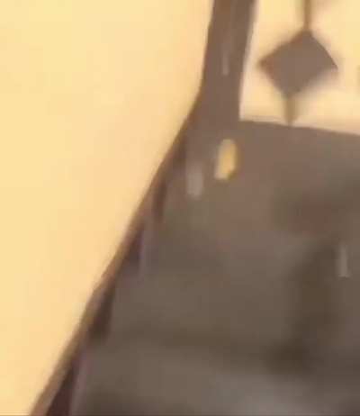 Guys walks over a man for sleeping in the building stairway