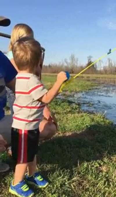 Kid catches fish with toy fishing rod