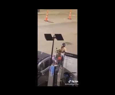 Guy on his motorbike shouting at a girl on the street, then rides away screaming.