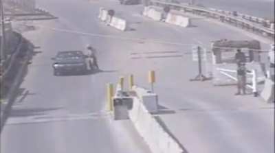 An AQI (Al Qaeda in Iraq) or ISI (Islamic State of Iraq) SVBIED / car-bomb attack against a checkpoint in Iraq manned by US forces in 2006.