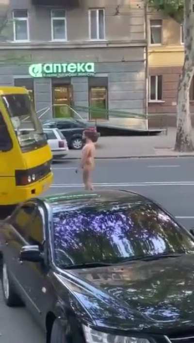 Naked guy expects traffic to drive around him