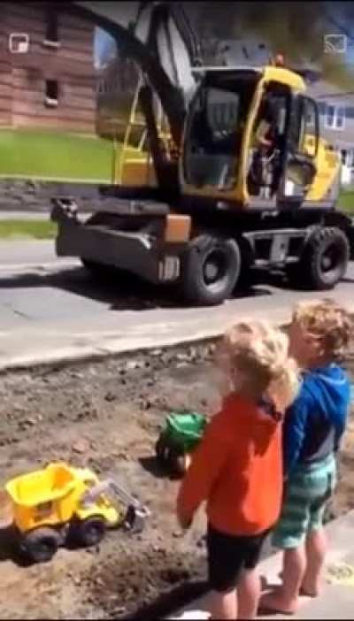 Construction worker precisely filling the kids toy trucks with soil and putting a smile on their faces