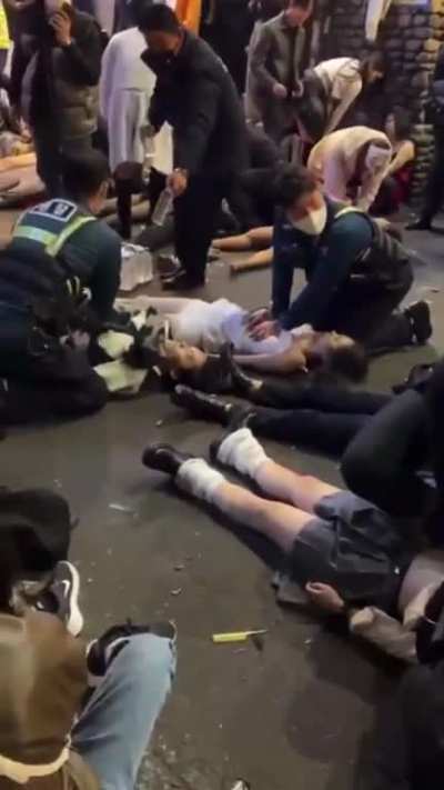 Video of first responders performing CPR to bunch of people in the middle of the street after an stampede of people got crushed during a Halloween event in South Korea. [NSFW]