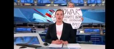 Russian state TV broadcast hijacked by an unidentified woman holding a poster calling to stop war, March 14 2022